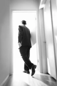 Man walking out through an open door
