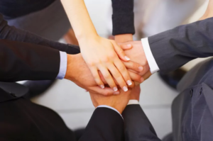 Team members stacking their hands together