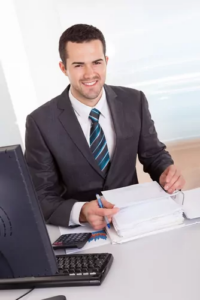 Investment professional reviewing documents at his desk