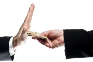 Hand refusing cash offered by another hand, representing a declined loan