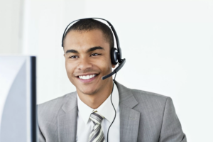 Customer service representative wearing a headset at a computer