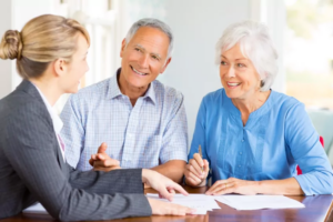 Financial advisor meeting with a smiling retired couple
