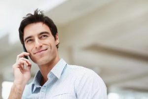 Smiling man talking on a mobile phone