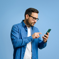 Man in glasses responding to a survey on his smartphone